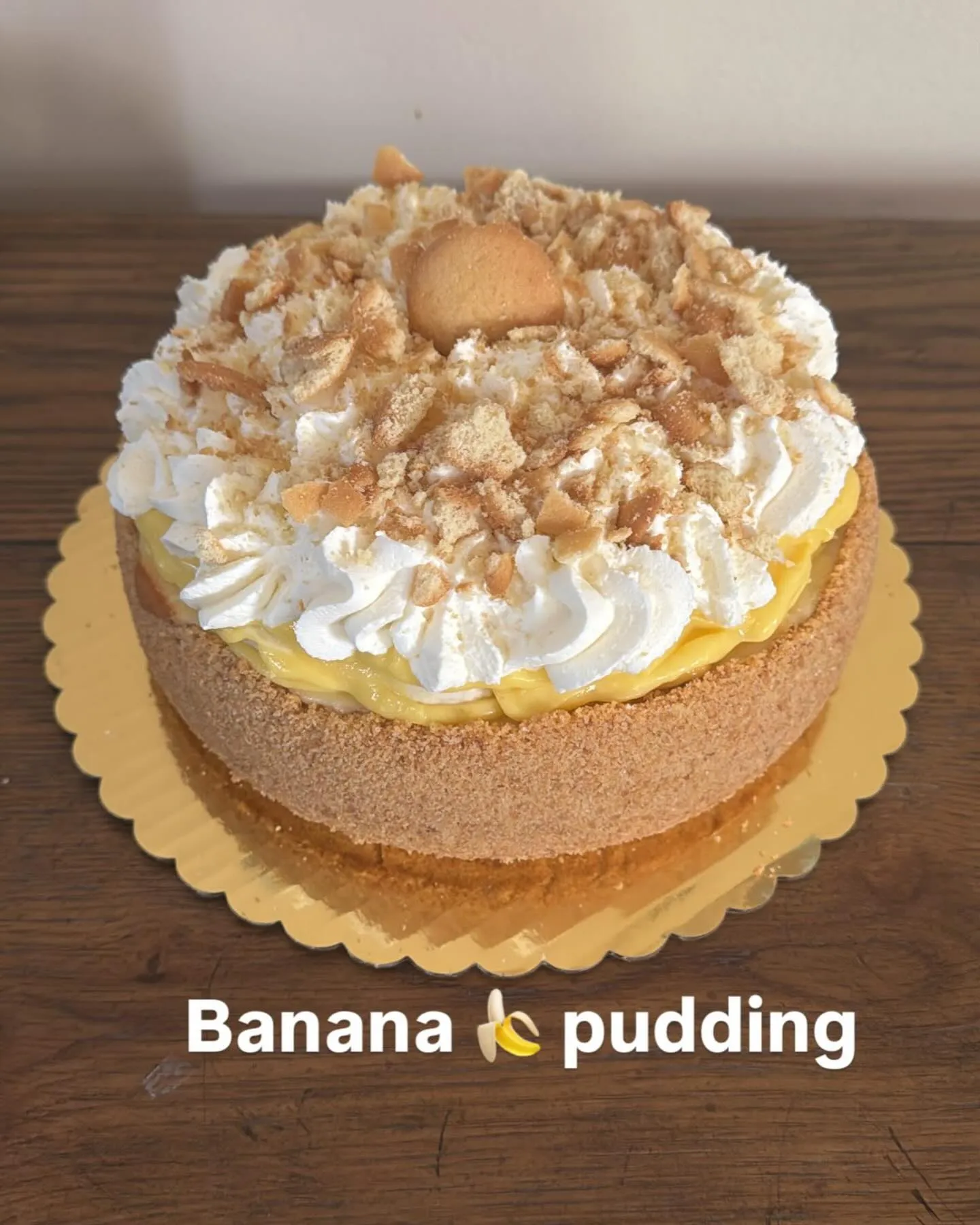 A banana pudding cheesecake topped with whipped cream and crushed vanilla wafers.