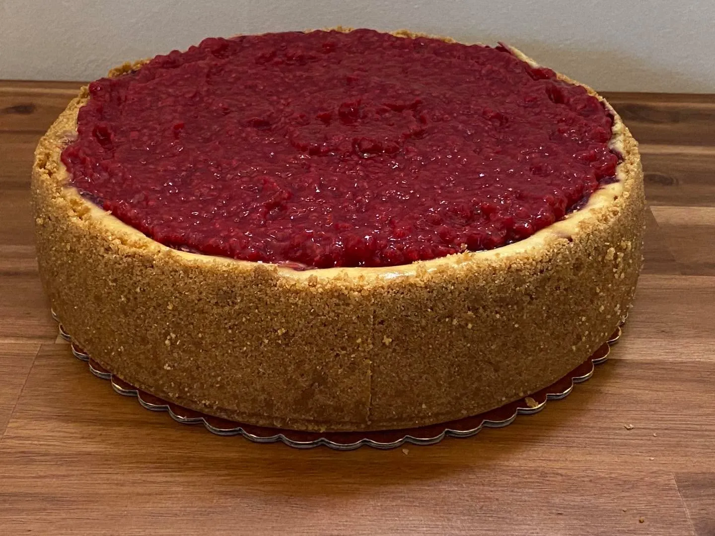 A raspberry cheesecake topped with raspberry compote.